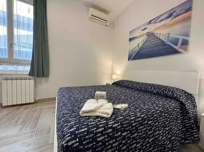 a bedroom with a bed with a towel on it at Family Flat near Metro A in Rome