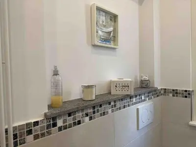 a kitchen with a counter with a bottle of orange juice at Family Flat near Metro A in Rome