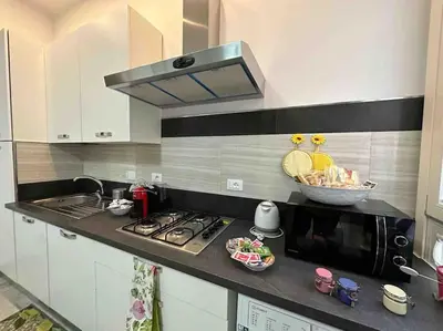 a kitchen with a stove and a microwave at Family Flat near Metro A in Rome