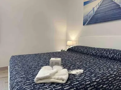 a bedroom with a bed with towels on it at Family Flat near Metro A in Rome