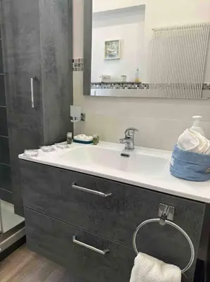 a bathroom with a sink and a mirror at Family Flat near Metro A in Rome