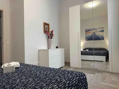 a bedroom with a bed and a large mirror at Family Flat near Metro A in Rome