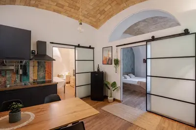 a living room with a table and a bedroom at NEW Look8 Vatican Home in Rome