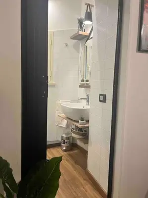 a bathroom with a white sink and a mirror at NEW Look8 Vatican Home in Rome
