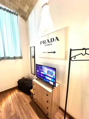 a living room with a flat screen tv on a stand at NEW Look8 Vatican Home in Rome