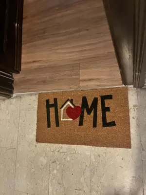 a welcome mat on a floor with the word home at NEW Look8 Vatican Home in Rome