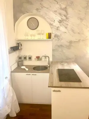 a kitchen with a sink and a clock on the wall at NAVONA SUITE VIOLA in Rome