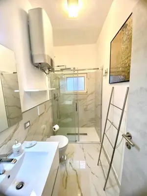 a bathroom with a shower and a toilet and a sink at NAVONA SUITE VIOLA in Rome