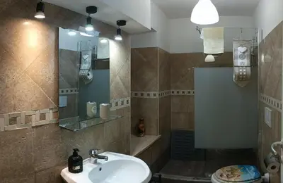 a bathroom with a sink and a shower and a tub at casa di lella ai musei vaticani in Rome