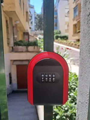 a red and black mailbox on a pole at casa di lella ai musei vaticani in Rome