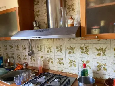 a kitchen counter with a stove top in a kitchen at Green house di Alberto in Rome