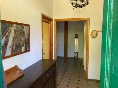 a room with a dresser and a mirror and a hallway at Green house di Alberto in Rome