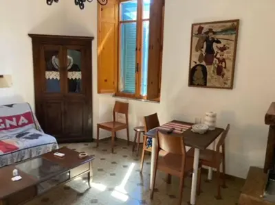 a living room with a table and a dining room at Green house di Alberto in Rome