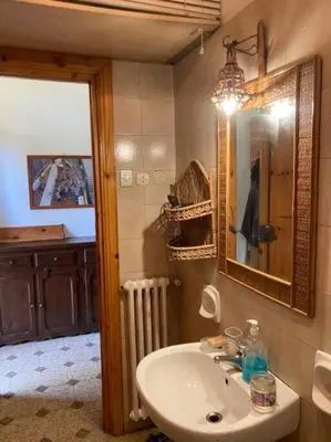 a bathroom with a sink and a mirror at Green house di Alberto in Rome