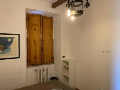 a room with a wooden cabinet and a table at Green house di Alberto in Rome