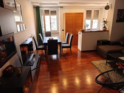 a living room with a table and chairs and a kitchen at Quarto Piano - intero alloggio a Roma in Rome