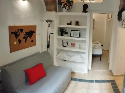 a living room with a couch and a red pillow at Casa Bertani in Rome
