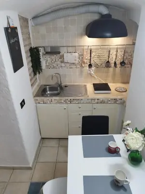 a small kitchen with a sink and a table at Casa Bertani in Rome