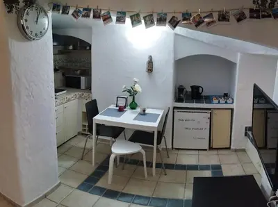 a small kitchen with a white table and chairs at Casa Bertani in Rome