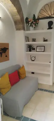 a couch with colorful pillows in a room at Casa Bertani in Rome