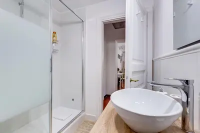 a bathroom with a white sink and a shower at Pigna suite in Rome