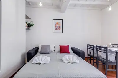 a dining room with a table with two pillows on it at Pigna suite in Rome