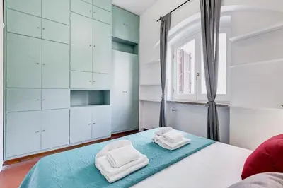 a bedroom with a bed with two towels on it at Pigna suite in Rome