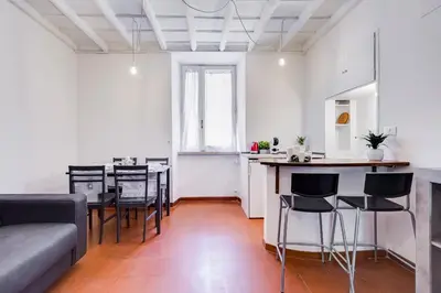 a living room with a couch and a table and chairs at Pigna suite in Rome