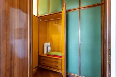 a room with a closet with a bed and a dresser at 2 Vatican St Peter's Daniele apartment Barone in Rome