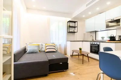 a living room with a couch and a kitchen at Modern & Elegant by NDP rent in Rome