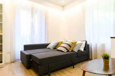 a living room with a couch and a table at Modern & Elegant by NDP rent in Rome