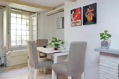a dining room with a white table and chairs at Al moretto in Rome