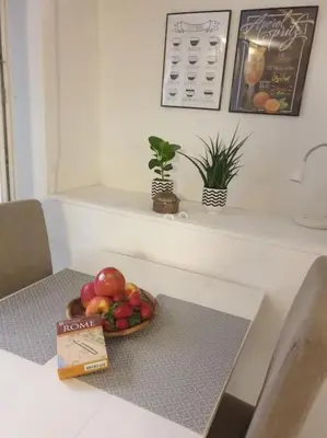 a bowl of fruit on a table in a room at Al moretto in Rome