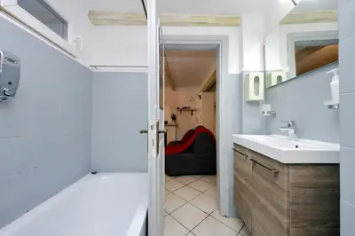 a bathroom with a sink and a tub and a shower at Al moretto in Rome