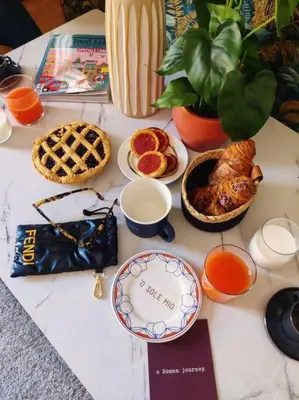 a table topped with food and a plate of food at 4 Townhouse by the Spanish Steps in Rome