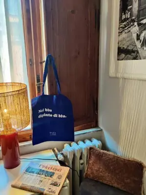a blue bag sitting on a desk next to a lamp at 4 Townhouse by the Spanish Steps in Rome