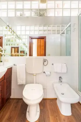 a white bathroom with a toilet and a sink at 4 Townhouse by the Spanish Steps in Rome