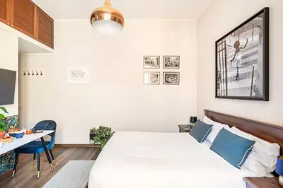 a bedroom with a bed and a table and a desk at 4 Townhouse by the Spanish Steps in Rome