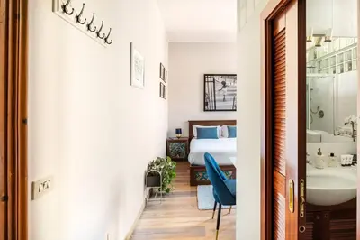 a hallway with a bedroom with a bed and a sink at 4 Townhouse by the Spanish Steps in Rome