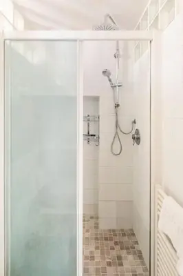 a shower with a glass door in a bathroom at 4 Townhouse by the Spanish Steps in Rome