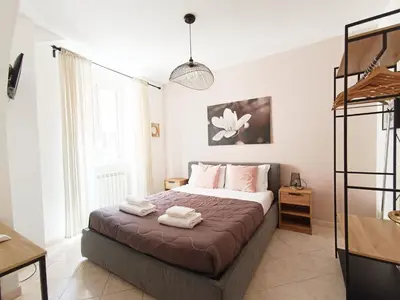 a bedroom with a bed with two towels on it at LAVINIA VATICAN HOME in Rome