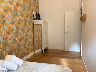 a bedroom with a floral wallpaper and a bed at Il Nido Apartment in Rome