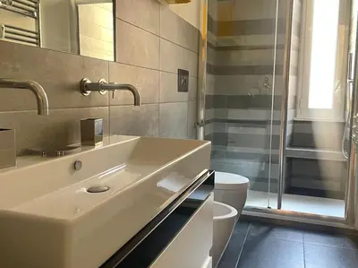 a bathroom with a sink and a toilet and a shower at Il Nido Apartment in Rome