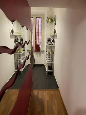 a room with a staircase with shoes on shelves at DOMUS ANNIA Guest House, The Amazing Colosseum in Rome
