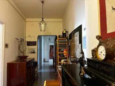 a room with a clock on a counter and a hallway at Claudia B&B in Rome
