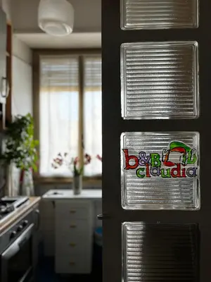 a kitchen with a refrigerator with a sign on the door at Claudia B&B in Rome