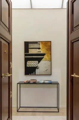 a table in a room with a picture of a piano at Le Case di Andrea - Luxe Rome apartment in Rome