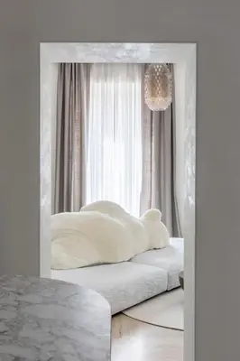 a white bedroom with a bed in a mirror at Le Case di Andrea - Luxe Rome apartment in Rome