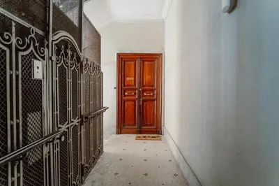 a hallway with a wooden door in a building at Valentine's Dream in Rome
