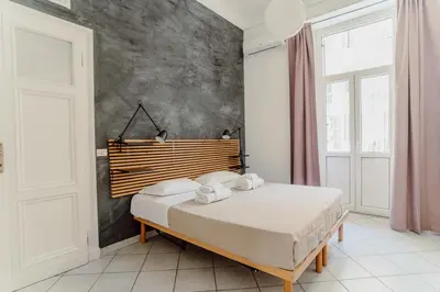 a bedroom with a bed with a wooden headboard at Valentine's Dream in Rome